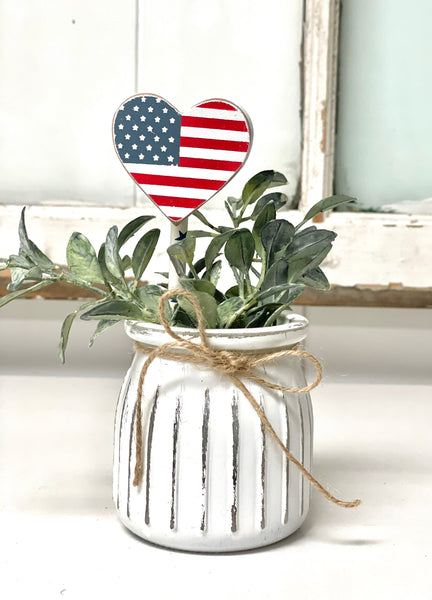 Seasonal floral arrangement, white rustic vase