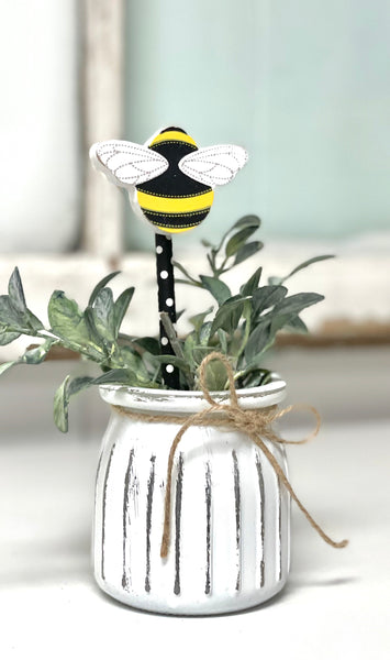 Seasonal floral arrangement, white rustic vase